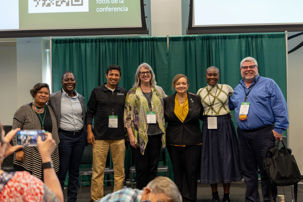 Assistant secretary of labor Lisa Gomez poses with worker co-op advocates at the 2024 Worker Co-op Conference.